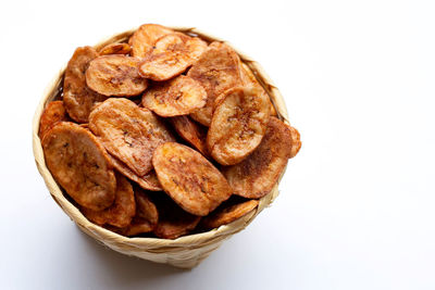 High angle view of bread in bowl against white background