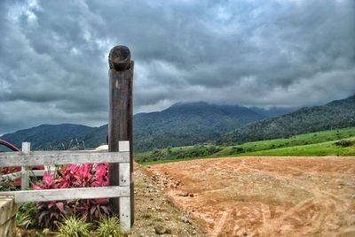 Scenic view of mountains against cloudy sky