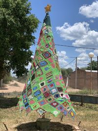 Low angle view of decoration hanging on tree against sky