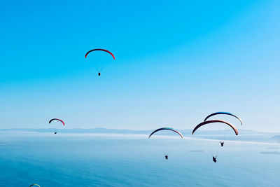 Kite flying over sea against sky