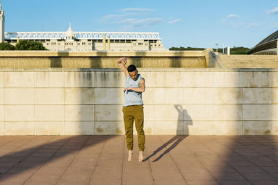 Rear view of man standing against wall