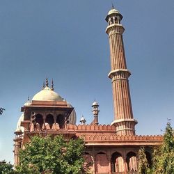 Low angle view of built structure against clear blue sky