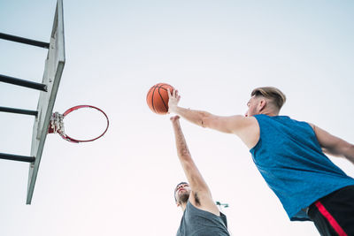 Young man playing with basketball