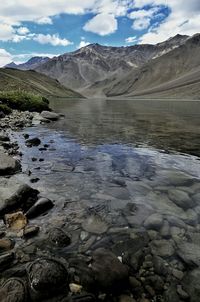 Scenic view of lake against cloudy sky