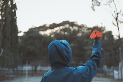 Young women in hoodie holding paper aircraft  prepare for throwing , hope and dream concept