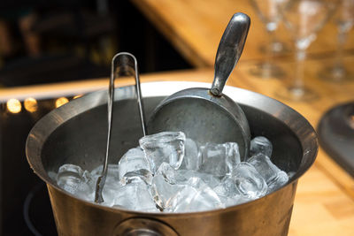Metal ice bucket for cocktails with large ice cubes with tongs and scoop