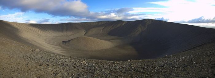 Scenic view of mountains against cloudy sky