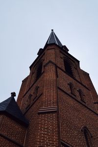 Low angle view of clock tower against clear sky