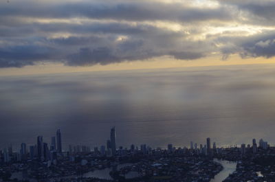 View of cityscape against cloudy sky