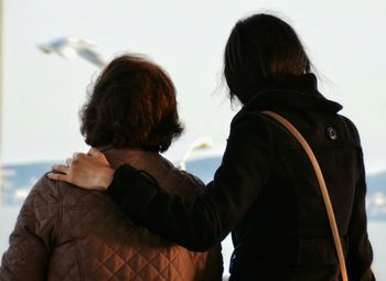 Rear view of woman photographing