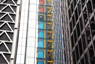 Low angle view of modern glass building in city