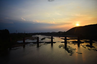 Scenic view of river against sky during sunset