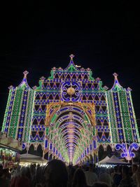 Group of people in illuminated building at night