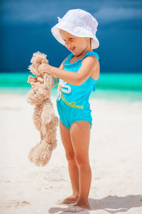 Full length of cute baby girl on beach