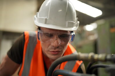 Rear view of man working in factory