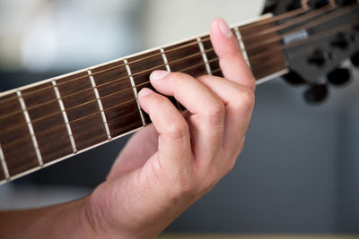 Cropped hand playing guitar