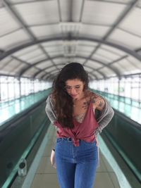 Beautiful woman standing at railroad station