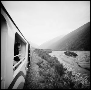 Car on road by land against sky