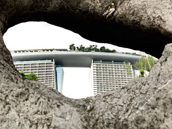 Buildings seen through hole of rock