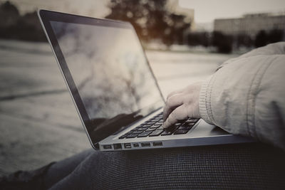 Close-up of woman using laptop