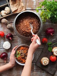 The girl's hands are applied buckwheat porridge. national russian folk cuisine.