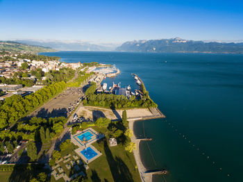 High angle view of city by sea against sky