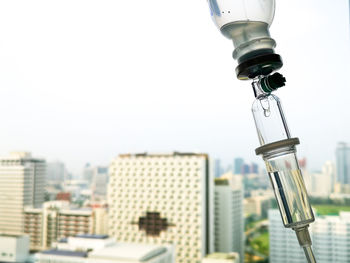 Low angle view of light bulb against sky