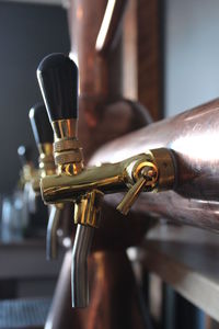 Close-up of beer taps at microbrewery