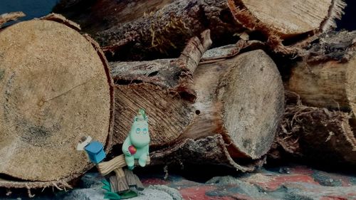 Close-up of stuffed toy on logs