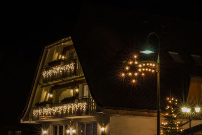 Low angle view of illuminated building against sky at night