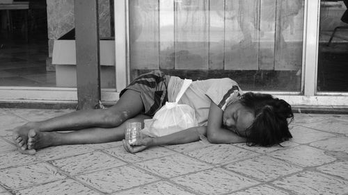 Woman lying down on floor at home