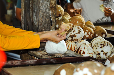 Cropped hand of person preparing food