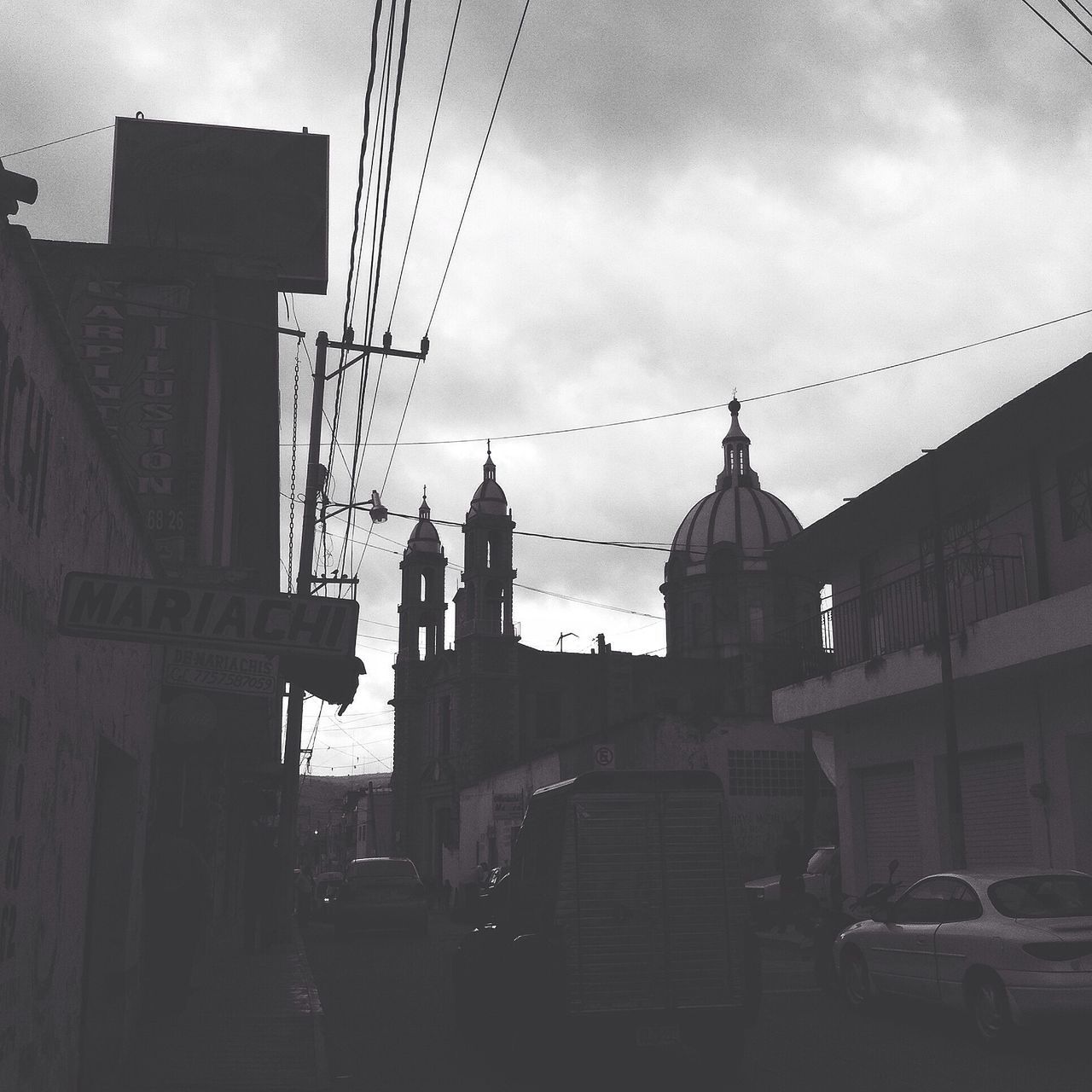 architecture, building exterior, built structure, sky, cloud - sky, city, cloudy, silhouette, low angle view, church, tower, dusk, building, cloud, sunset, religion, outdoors, travel destinations, place of worship, weather