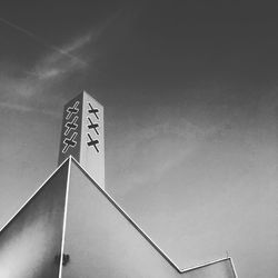 Low angle view of sign on road against sky