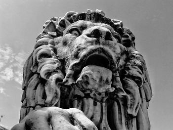 Low angle view of a lion statue against sky