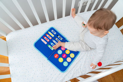 High angle view of cute girl playing with toys on table