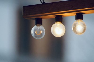 Electric bulbs hanging on wooden house in the city 