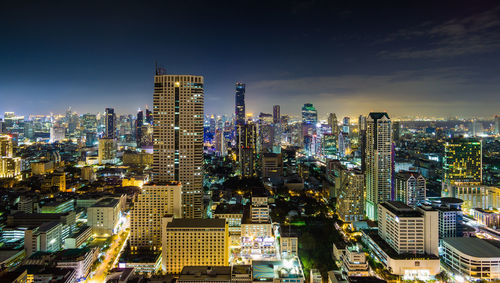 Aerial view of illuminated buildings in city at night