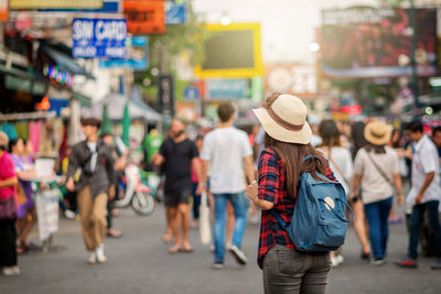 Rear view of people walking on street