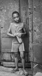 Full length portrait of girl standing outdoors