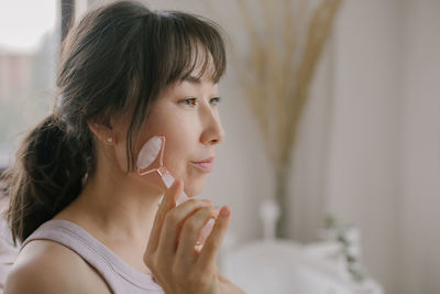 Portrait of woman looking away at home