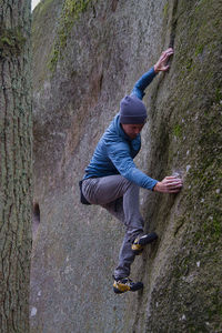 Side view of senior man on rock