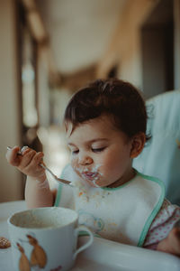 Midsection of boy holding ice cream in bowl