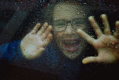 Close-up portrait of raindrops on glass window