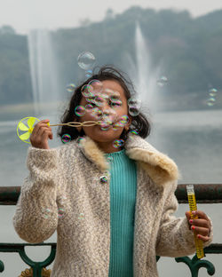 Portrait of young woman standing outdoors