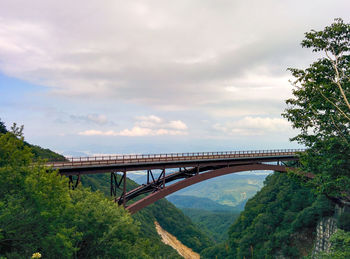 Low angle view of train on bridge against sky