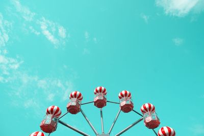 Low angle view of pink flowers against blue sky