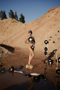 Full length of woman standing on sand at beach