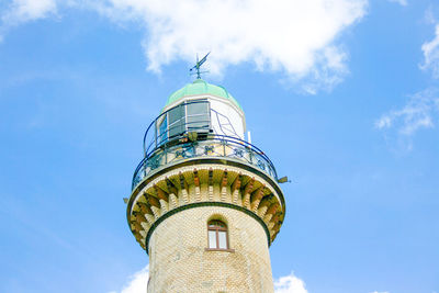 Low angle view of lighthouse on building against sky