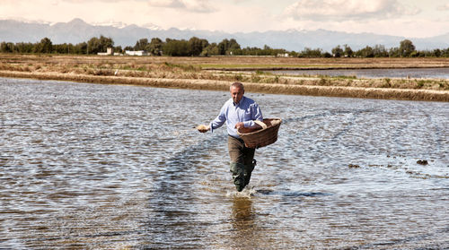 Full length of man standing in water